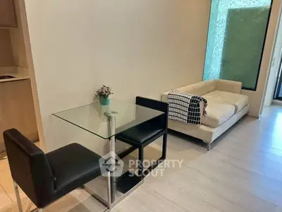 Modern living room with glass table and cozy sofa, perfect for urban living.