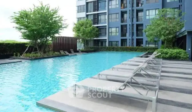 Luxurious apartment complex with a stunning outdoor pool and modern design.