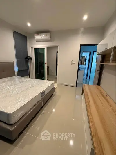 Modern bedroom with sleek design and air conditioning in a stylish apartment.