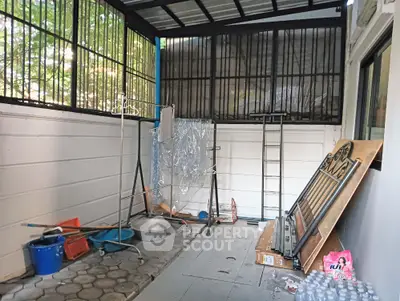 Spacious storage area with ample natural light and secure metal grilles, ideal for versatile use.