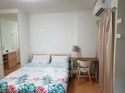 Cozy bedroom with modern decor and air conditioning, perfect for relaxation.