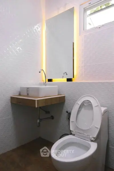 Modern bathroom with stylish sink and illuminated mirror