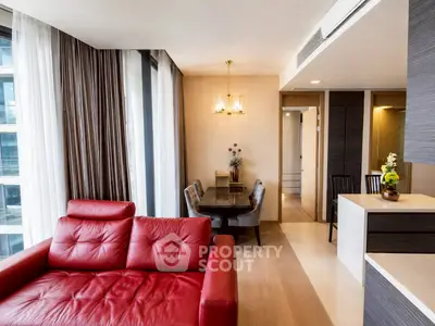 Modern living room with red leather sofa and dining area in luxury apartment