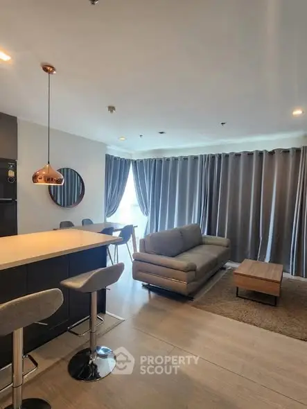 Modern living room with stylish furniture and open kitchen layout