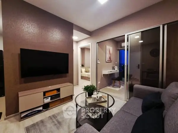 Modern living room with sleek TV setup and cozy seating area