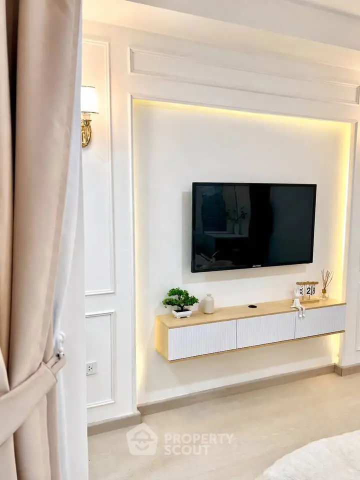 Modern living room with wall-mounted TV and elegant decor