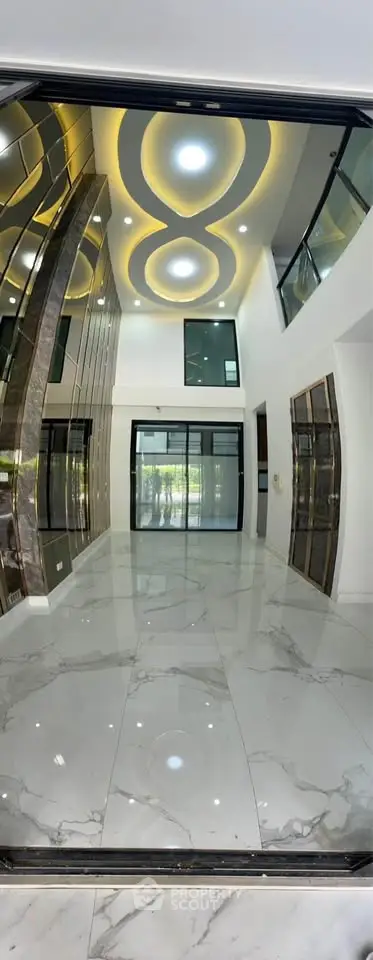Luxurious modern entrance with high ceilings and elegant marble flooring