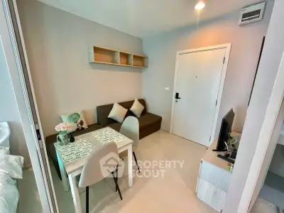 Cozy living room with modern decor and dining area in a compact apartment