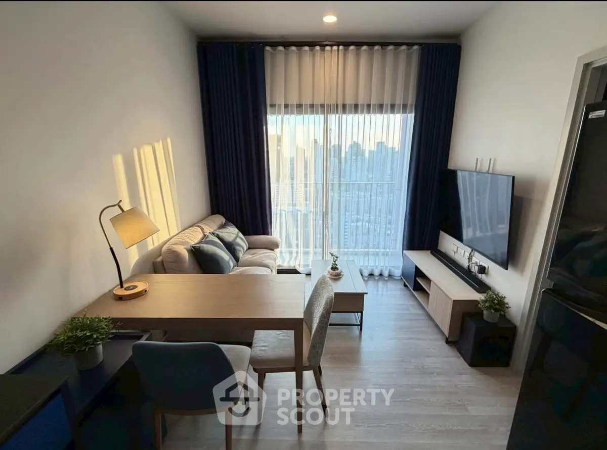 Modern living room with city view, cozy seating, and stylish decor