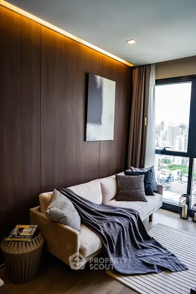Modern living room with city view, cozy sofa, and elegant decor