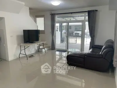 Spacious living room with modern furniture and large windows for natural light.
