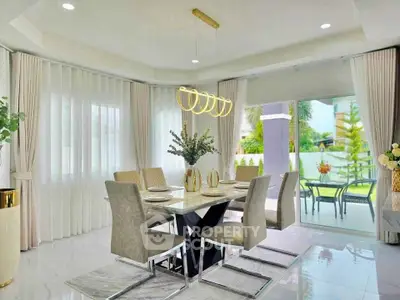 Elegant dining area with modern chandelier and garden view, perfect for family gatherings.