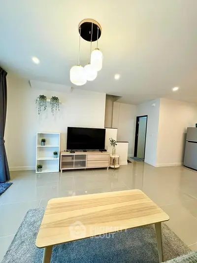 Modern living room with sleek furniture and stylish lighting in a contemporary apartment.