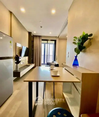 Modern living room with open layout, stylish decor, and balcony view in a contemporary apartment.