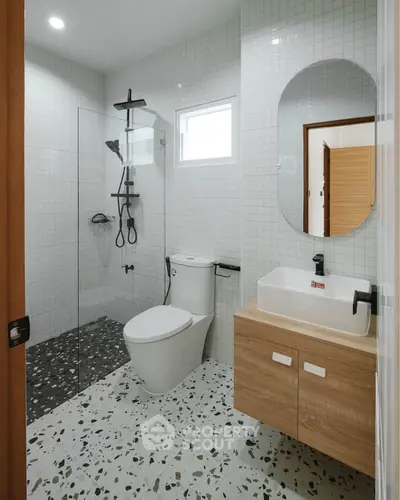 Modern bathroom with sleek fixtures and terrazzo flooring