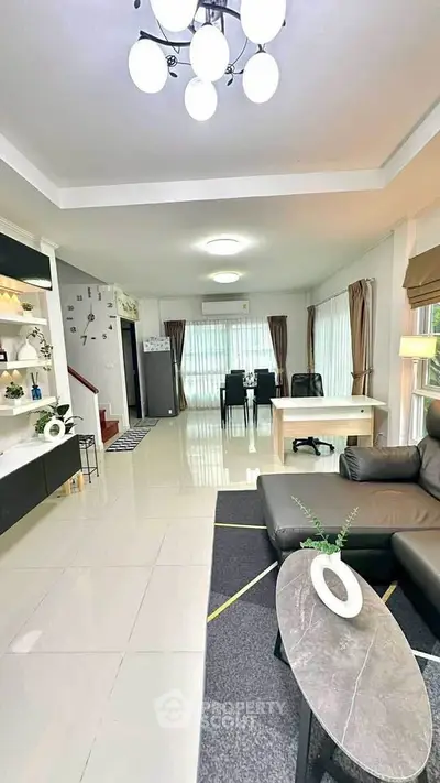 Spacious modern living room with elegant decor and ample natural light.