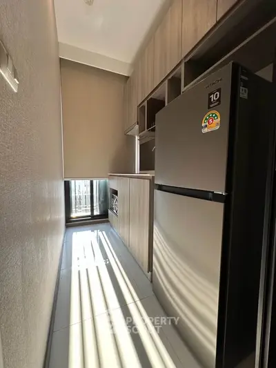 Modern kitchen with sleek appliances and ample storage in a compact layout.