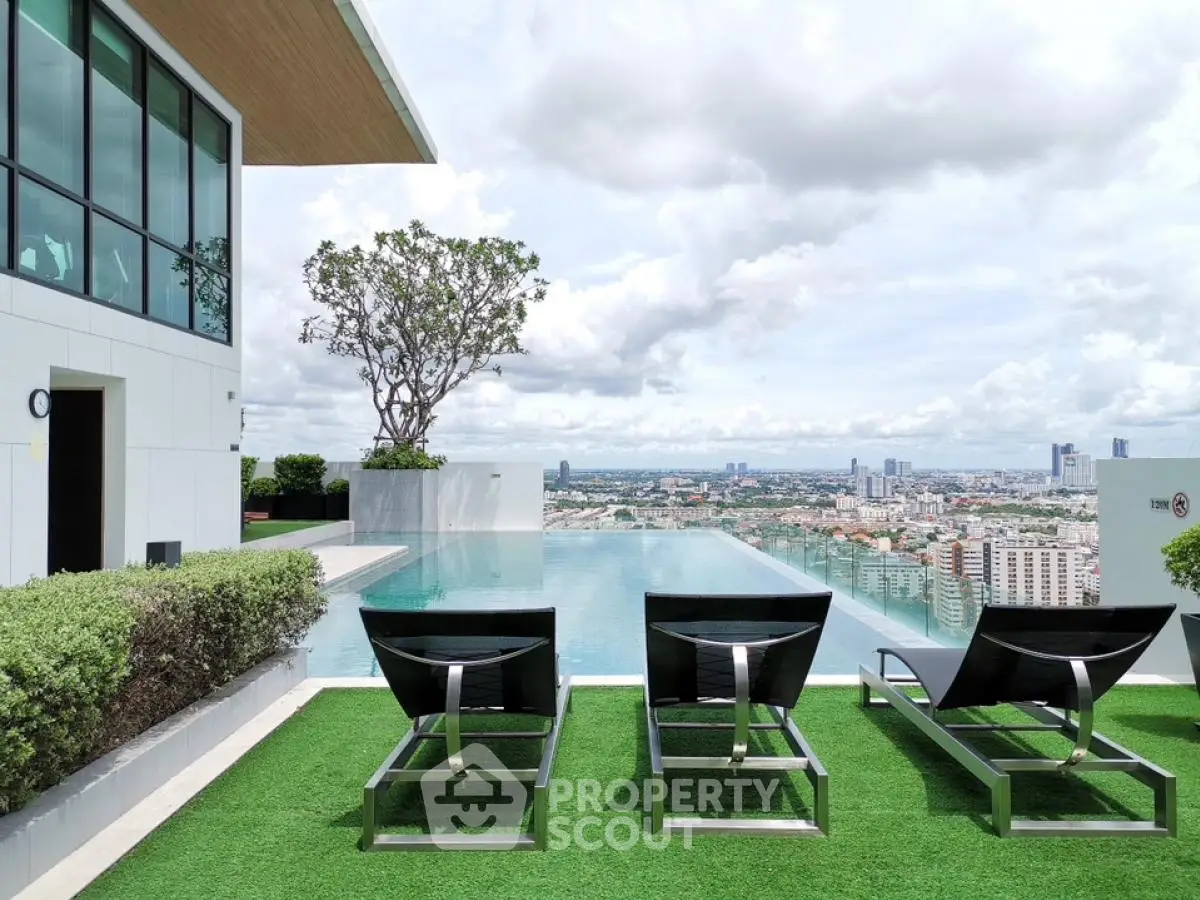 Luxurious rooftop infinity pool with stunning city skyline view and modern lounge chairs.