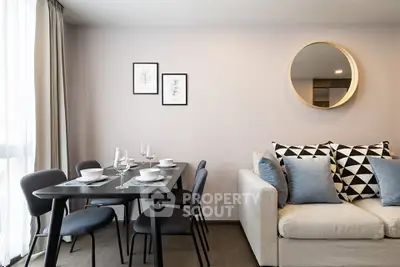 Modern living room with stylish dining area and cozy sofa, perfect for urban living.