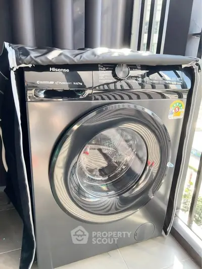 Modern washing machine on balcony with sleek design and energy efficiency.