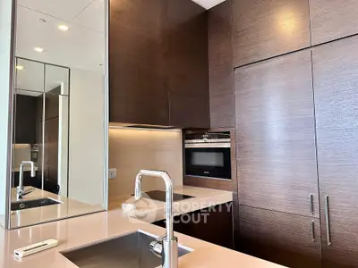 Modern kitchen with sleek cabinetry and built-in appliances in a luxury apartment.