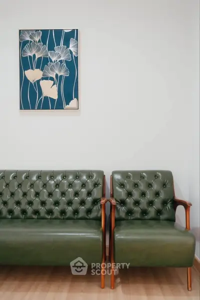 Stylish green leather seating in modern living room with elegant wall art