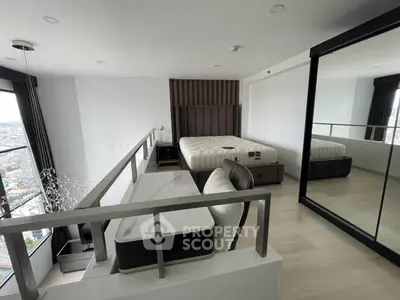 Modern loft bedroom with city view, featuring stylish furniture and large mirror closet.