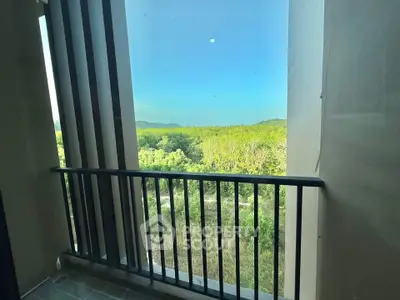 Scenic balcony view overlooking lush greenery and distant hills