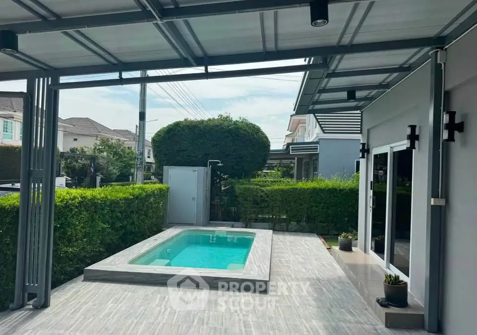 Modern home exterior with private pool and lush greenery, perfect for relaxation and outdoor entertainment.