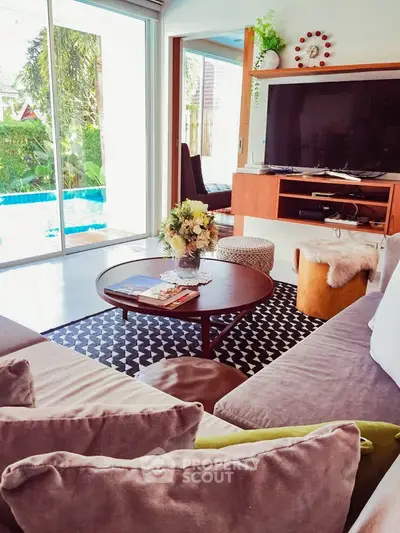 Chic living room with modern decor and pool view, perfect for relaxation and entertainment.