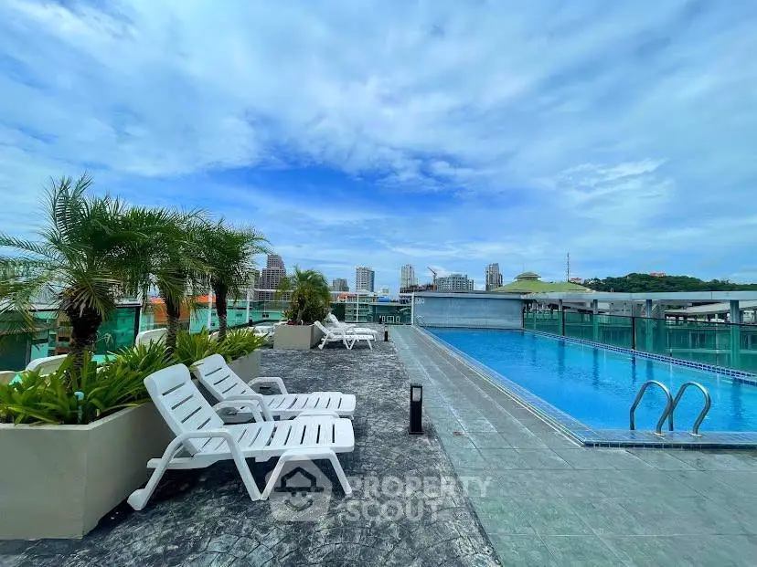 Luxurious rooftop pool with city skyline views and lush greenery.