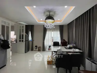 Modern living room with elegant chandelier and floor-to-ceiling curtains
