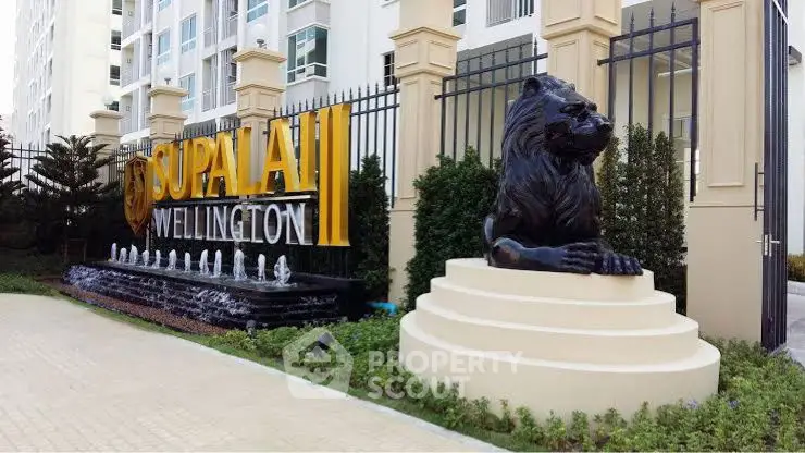 Luxurious entrance of Supalai Wellington with lion statue and elegant water feature.