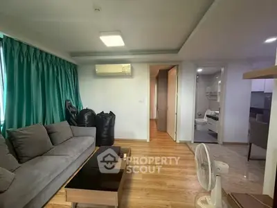 Spacious living room with modern decor and wooden flooring