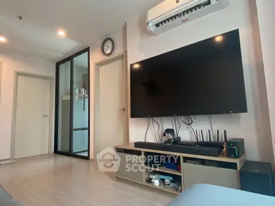 Modern living room with large TV and sleek air conditioning unit