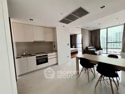 Modern open-plan kitchen and living area with city view, sleek design and natural light.