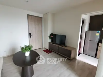 Modern living room with sleek furniture and open kitchen view, perfect for contemporary living.