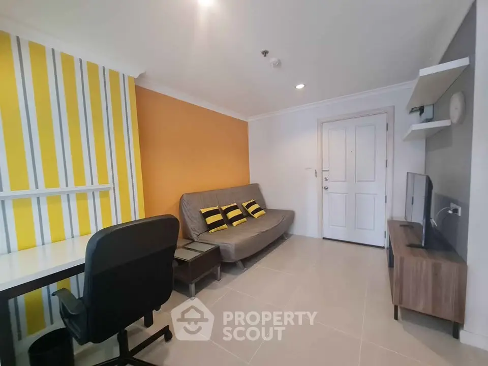 Modern living room with vibrant yellow accent wall and sleek furniture