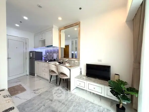 Modern open-layout living room with stylish kitchen and cozy dining area