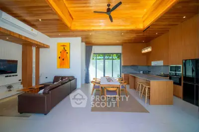 Spacious modern living room with open kitchen and elegant wooden ceiling