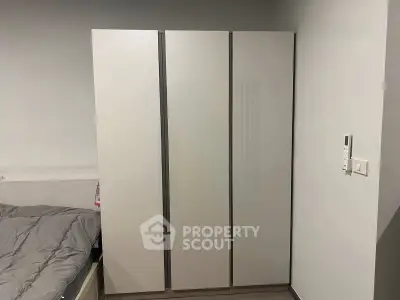 Modern bedroom with sleek wardrobe and cozy bed setup