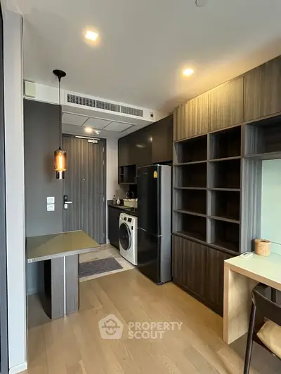 Modern kitchen with sleek cabinetry and built-in appliances in a stylish apartment.