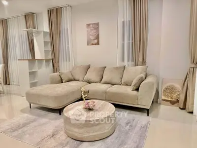 Luxurious living room with elegant beige sofa and modern decor, perfect for relaxation and entertaining.