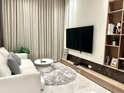 Modern living room with sleek TV setup and cozy seating area