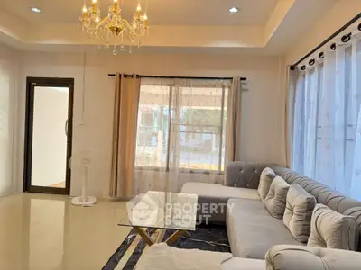 Elegant living room with chandelier and large sectional sofa