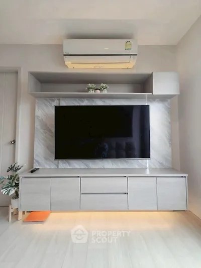 Modern living room with sleek TV unit and air conditioning