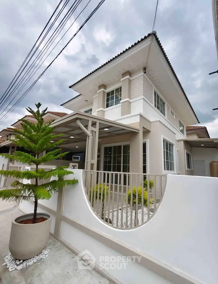 Elegant two-story house with modern design and landscaped front yard