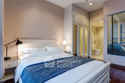 Elegant bedroom with ensuite bathroom and cozy lighting