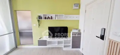 Modern living room with stylish TV unit and green accent wall