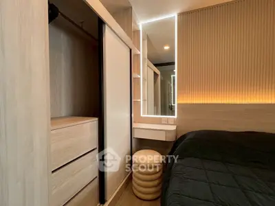 Modern bedroom with built-in wardrobe and stylish lighting